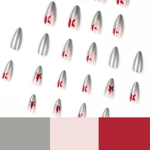 Almond-shaped press-on nails with silver French tips and red star patterns on white background
