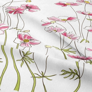 Macro shot of white fabric texture with pink floral pattern and green leaf details
