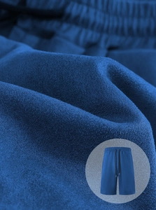 Detail of dark blue men's sports shorts fabric with black drawstring and elastic waist