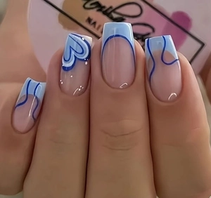 Close-up of square nails with deep blue heart patterns and abstract wavy textures