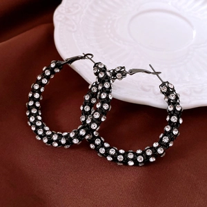 Detail shot of vintage flower earrings with black metal and sparkling rhinestones