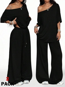 Detail of black two-piece lounge set featuring off-shoulder top and drawstring wide-leg pants