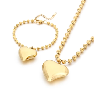 Golden bead chain necklace and bracelet set with 3D heart charms on white background