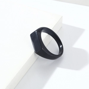 Close-up of a black titanium steel signet ring with a minimalist rectangular flat top