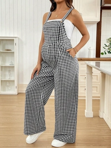 Relaxed black and white plaid maternity jumpsuit overalls with adjustable metal buckle straps