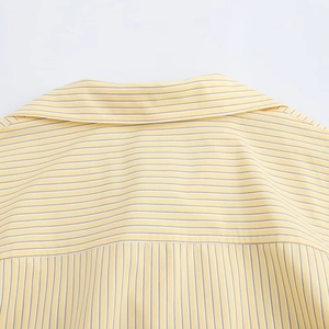Detail view of the yellow striped shirt collar and back yoke stitching construction
