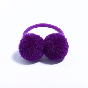 Close-up of purple double pom-pom hair tie with elastic band on white background