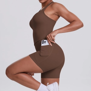 Detail of dark brown sports romper featuring a racerback and a side pocket for smartphone