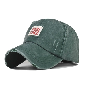 Close-up of distressed cotton baseball cap with red Maria embroidery and frayed details