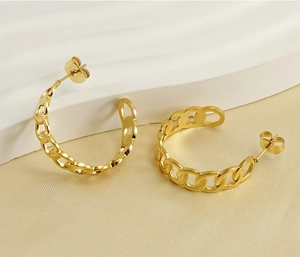 Detail of 18K gold plated interlocking link chain hoop earrings with butterfly backing