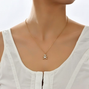 Gold bear pendant necklace with heart-shaped crystal on a minimalist chain for women