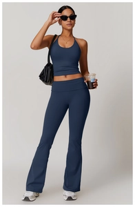 Macro shot of navy blue halter top and flared yoga pants set with smooth athletic fabric