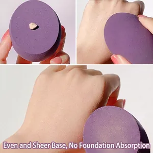 Purple makeup sponge with slanted design showing smooth foundation application process