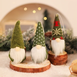 Three green knitted Christmas gnomes with long white beards on a wooden base