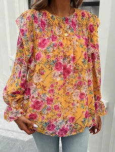 Detail showing smocking craftsmanship and ruffle shoulder on pink rose floral chiffon shirt