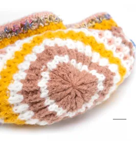 Macro shot of durable reinforced crown stitching on a colorful crochet knit beanie