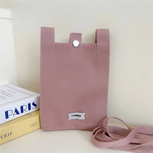 Close-up of pink knitted phone bag showing fabric texture and silver metal clasp detail