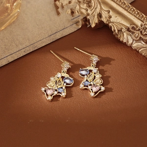 Macro detail of horse pendant earrings with colorful crystals on premium brown leather
