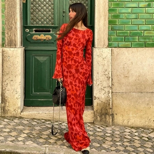 Detail of red floral maxi dress featuring bell sleeves and a flowing bohemian silhouette