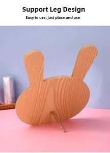 Detail of cute rabbit-shaped wooden makeup mirror with a stable metal support leg