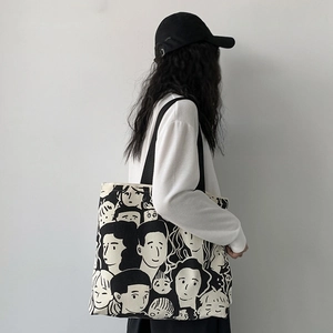 Detail of artistic hand-drawn black and white portrait pattern on canvas tote bag