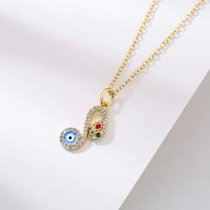Gold-plated snake necklace with zircon stones and blue evil eye pendant on white background