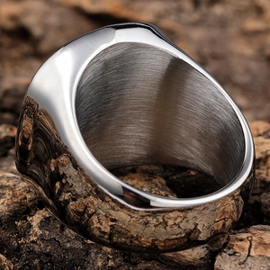 Macro shot of wide punk style stainless steel ring with polished and brushed metal finish