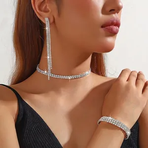 Detail of silver rhinestone jewelry set including fringe earrings, choker, and bracelet