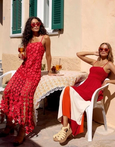Close-up of red French cut-out maxi dress with tassel details and high waist design