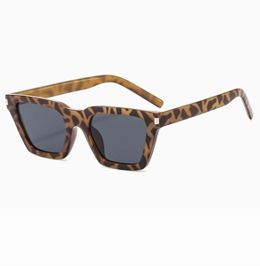 Close-up of vintage brown leopard print sunglasses with square dark gray lenses