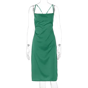 Detail of green satin slip dress featuring elegant cowl neck and sleek spaghetti straps
