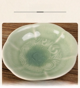 Macro shot of celadon ceramic petal plate with ice-crack glaze and spiral embossed texture