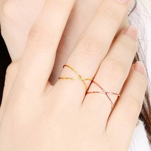 Close-up of minimalist interlocking double band rings in gold and rose gold finish