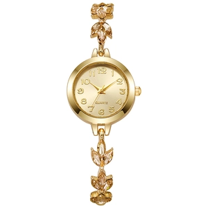 Elegant gold quartz watch for women with clover-shaped crystal bracelet on white background