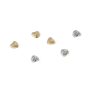 Macro shot of gold and silver heart-shaped CCB beads for DIY jewelry making