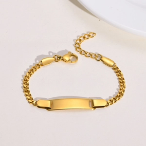 Detailed view of a polished gold stainless steel ID bracelet with a flat engravable bar