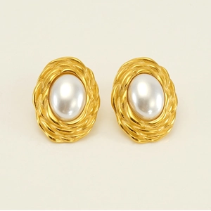 Detail of vintage oval gold-plated woven earrings featuring white faux pearls