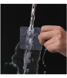 Close-up of waterproof transparent adhesive tape being washed under a flowing water stream