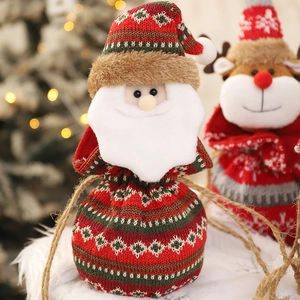 Knitted Christmas drawstring bags with Santa and reindeer designs for festive gifts