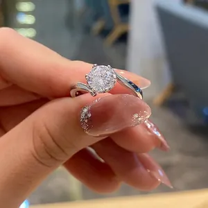Close-up of a large round-cut sparkling solitaire ring with silver twisted band details