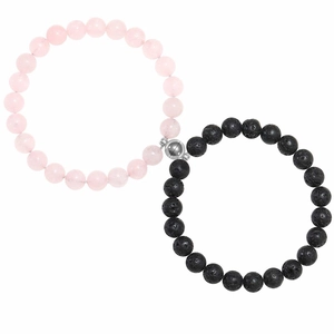 Detail of magnetic couple bracelets featuring matte black stone and pink quartz beads
