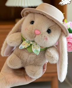Close-up of a cute plush rabbit doll featuring soft beige fur and a green floral scarf
