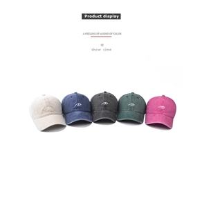 Detailed view of five vintage washed cotton baseball caps in various colors with embroidery