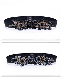 Detail of floral beaded patterns on black and navy blue elastic waist belts