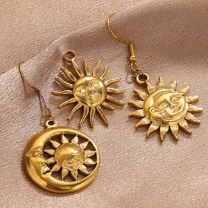 Close-up of vintage gold sun and moon pendants with intricate embossed details
