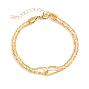 Close-up of two-tone braided metal chain with lobster clasp and adjustable extension