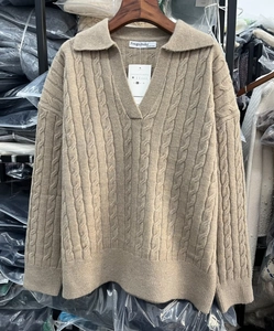 Close-up of khaki polo collar knit sweater featuring vertical cable knit texture and buttons