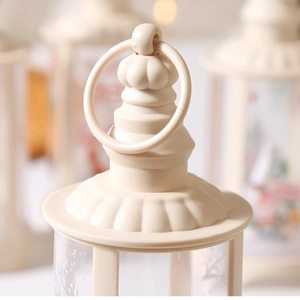 Detail view of cream white Christmas lantern featuring the top ring and textured relief