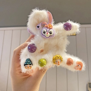 Detail of plush hair claw clip with StellaLou bunny and colorful cartoon charms