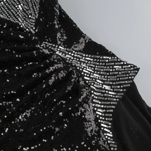 Close-up of silver rhinestones and black sequins on high-quality mesh dress fabric